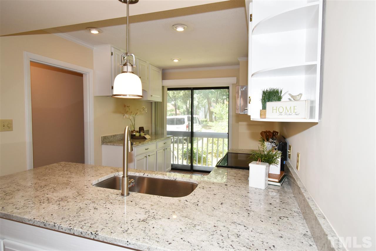 710 Green Ridge Drive Raleigh, NC 27609 - Photo 6 of 26 a view of a kitchen with a sink and a window