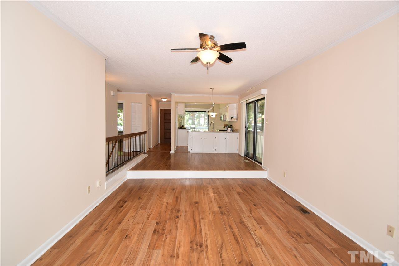 710 Green Ridge Drive Raleigh, NC 27609 - Photo 8 of 26 a view of a room with wooden floor ceiling fan and window