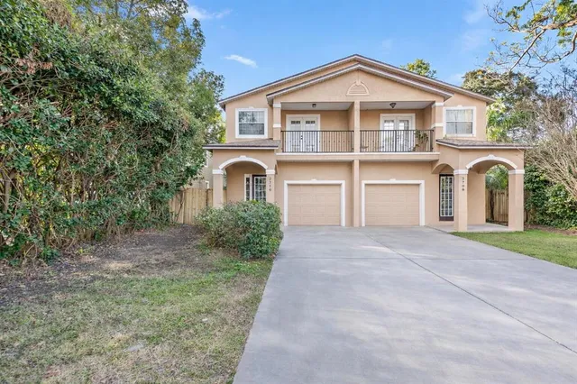 a front view of a house with a yard and garage