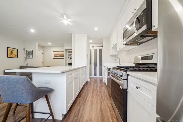 a kitchen with stainless steel appliances granite countertop a stove and a sink