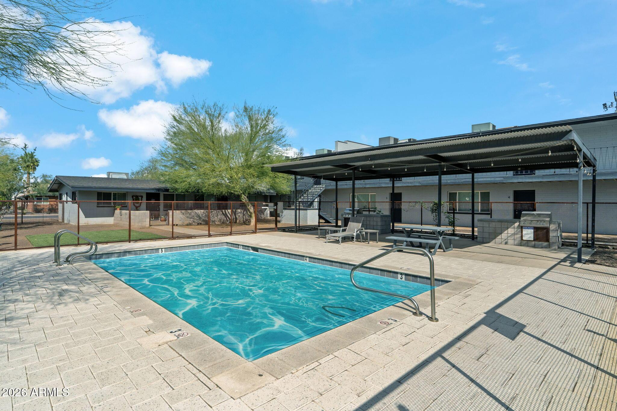 1707 North 18th Street, Unit B7 Phoenix, AZ 85006 - Photo 13 of 14 a swimming pool with outdoor seating and yard