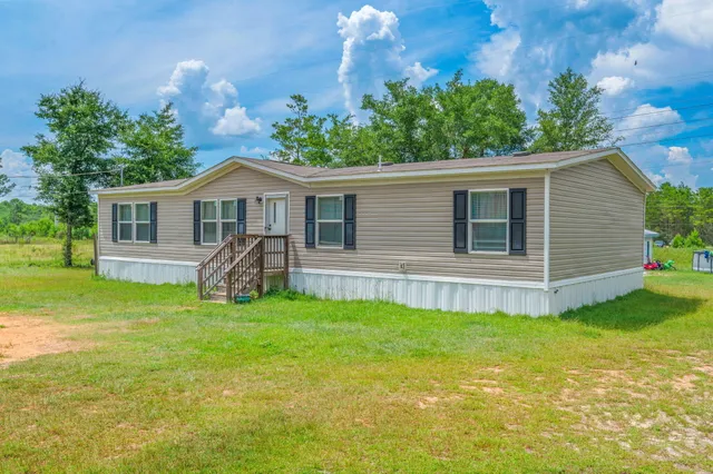 a view of a house with a backyard