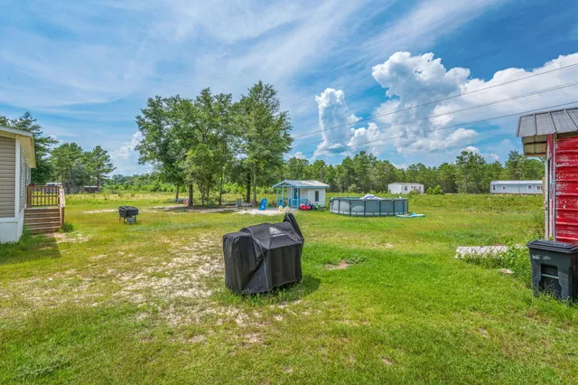 a view of a swimming pool with a yard