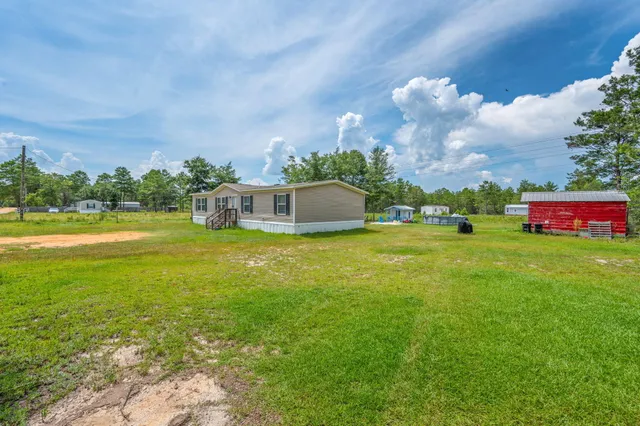 a view of a house with a big yard