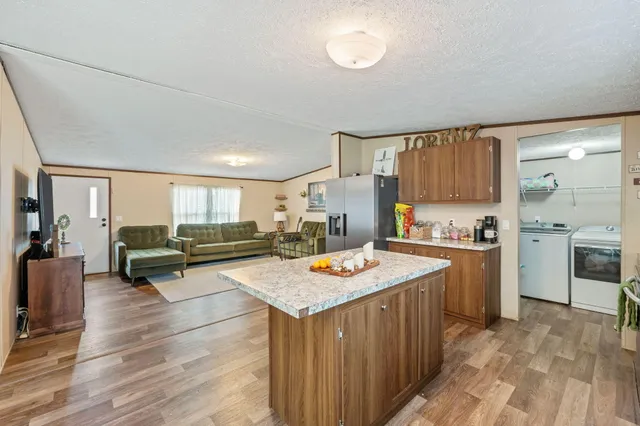 a kitchen with a stove a refrigerator and cabinets