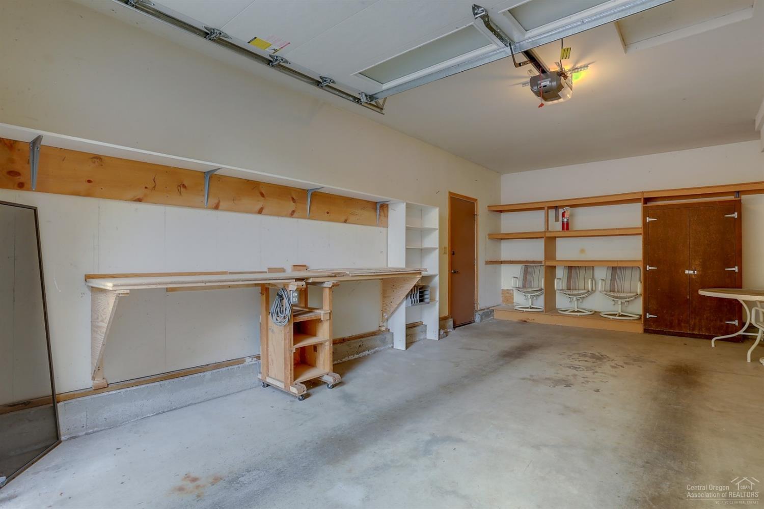 1414 Northwest Awbrey Road, Unit 1 Bend, OR 97703 - Photo 19 of 25 Nice sized single-car garage with shelvi