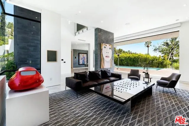 a living room with furniture a rug and a large window