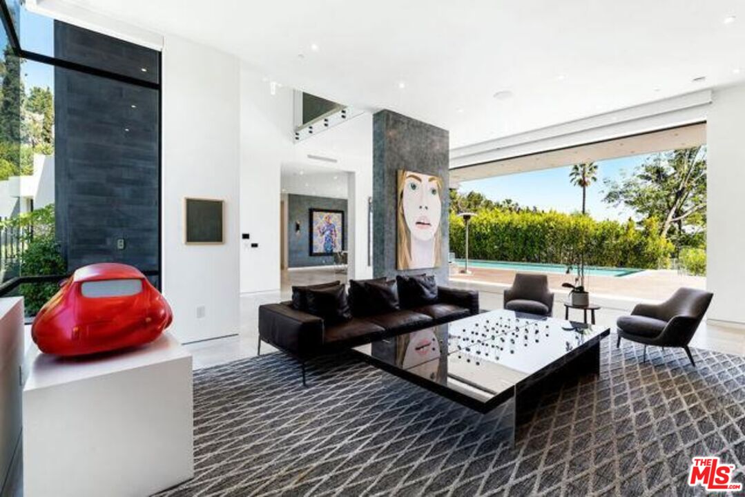 Undisclosed Address Beverly Hills, CA 90210 - Photo 16 of 47 a living room with furniture a rug and a large window