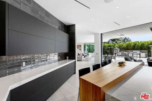 a large kitchen with sink and cabinets