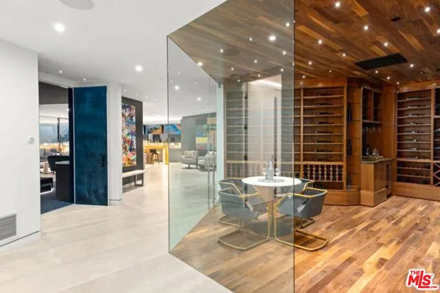 a view of a dining hall with a dining table chairs and entryway