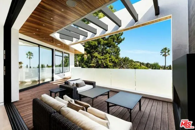 a balcony with furniture and a potted plant