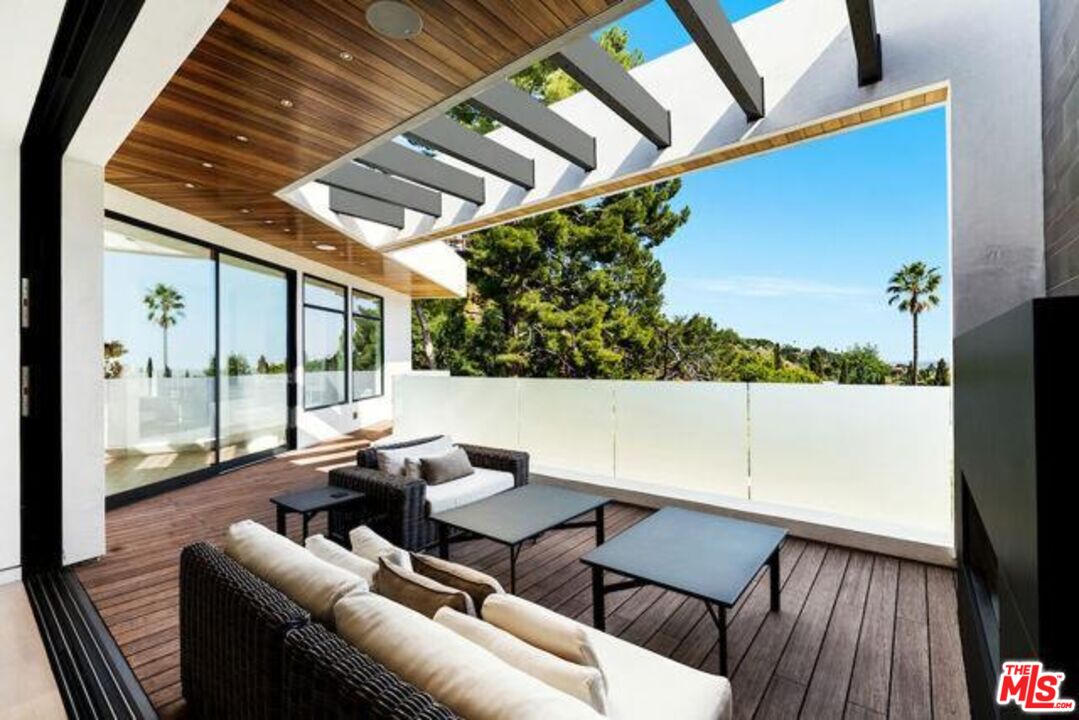 Undisclosed Address Beverly Hills, CA 90210 - Photo 3 of 47 a balcony with furniture and a potted plant