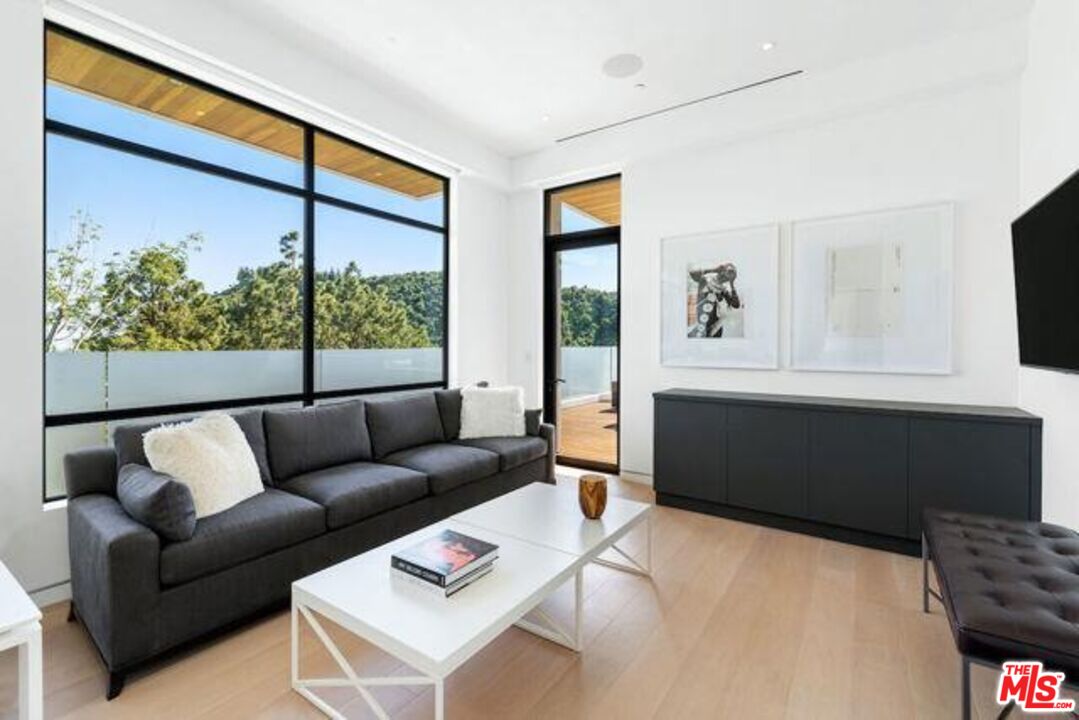 Undisclosed Address Beverly Hills, CA 90210 - Photo 35 of 47 a living room with furniture and a large window