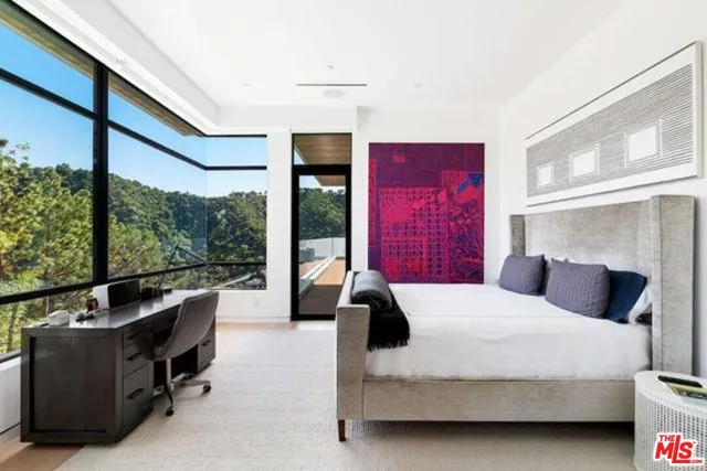 a bedroom with a bed and large window