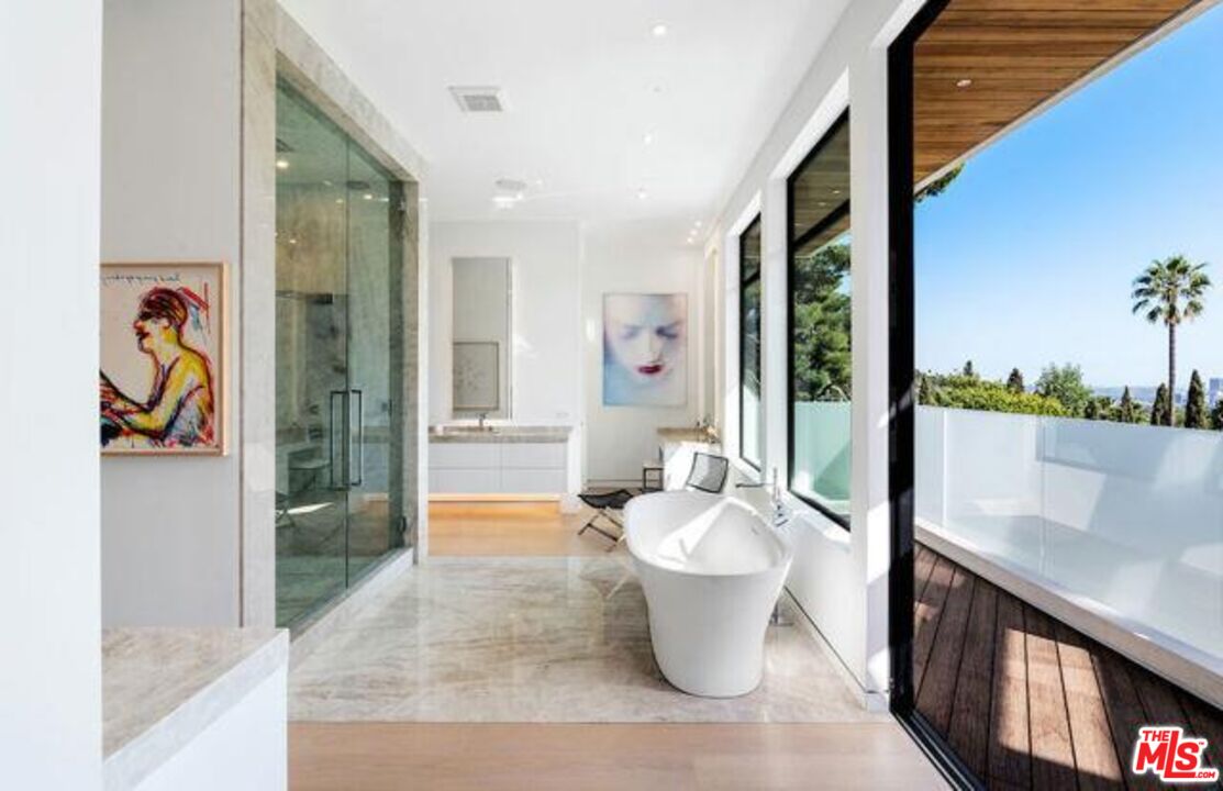 Undisclosed Address Beverly Hills, CA 90210 - Photo 4 of 47 a view of a large room with wooden floor and a potted plant