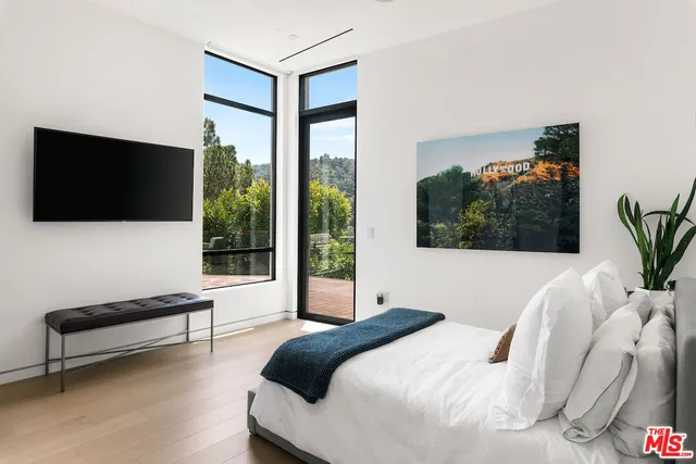 a bedroom with a bed and a flat screen tv