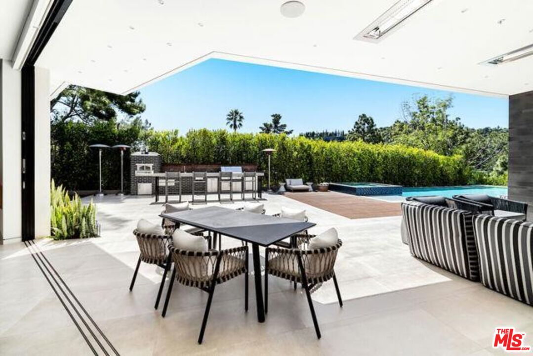 Undisclosed Address Beverly Hills, CA 90210 - Photo 6 of 47 a view of a dinning tables and chairs in patio