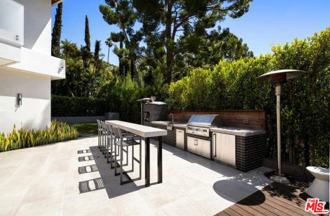 Undisclosed Address Beverly Hills, CA 90210 - Photo 9 of 47 a view of a chairs and table in the backyard