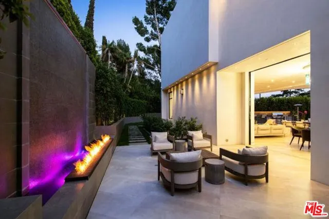 a view of swimming pool with outdoor seating and a potted plant
