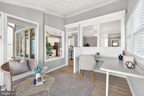 a living room with furniture potted plant and windows