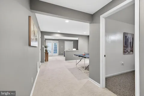 a view of a hallway with wooden floor windows and cabinet