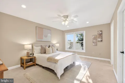 a spacious bedroom with a bed and a chandelier