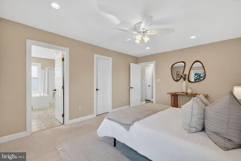 a bedroom with a large bed and a chandelier