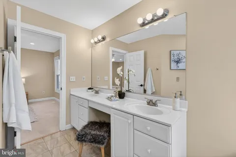 a bathroom with a sink a light fixture and a mirror