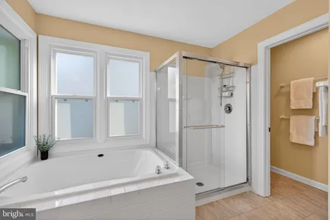 a bathroom with a tub shower and a sink