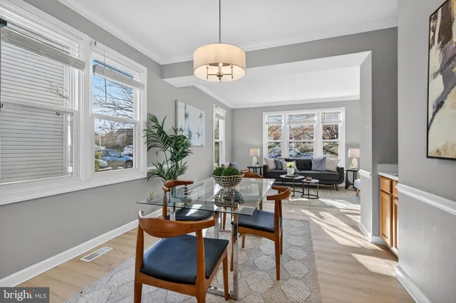 a living room with furniture a chandelier and a window