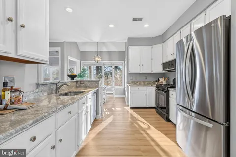 a kitchen with refrigerator a sink and cabinets