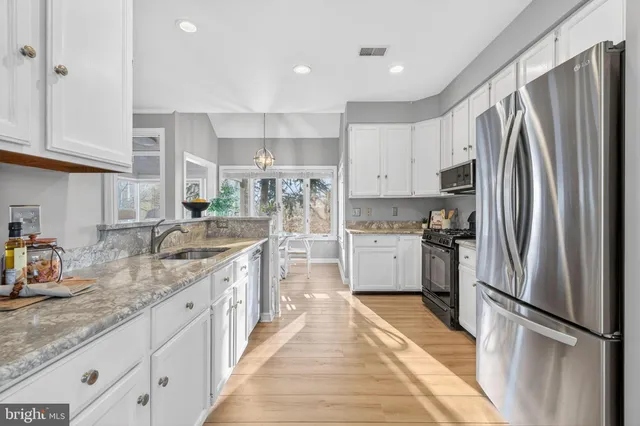a kitchen with refrigerator a sink and cabinets