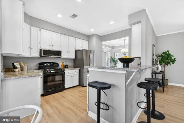 a kitchen with granite countertop a counter space a sink appliances and cabinets