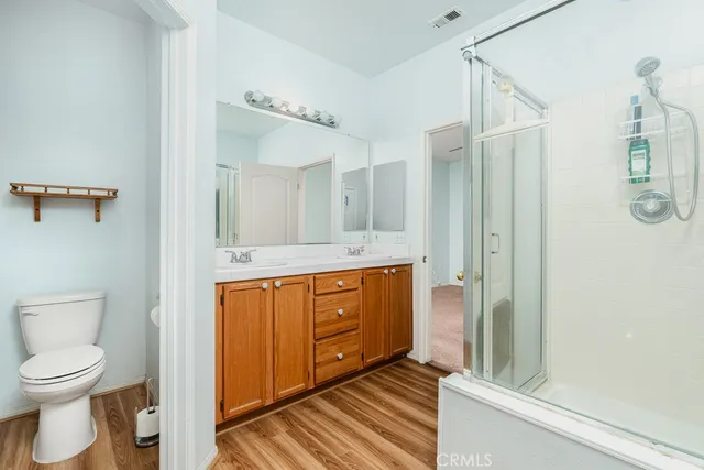 a spacious bathroom with a toilet a sink and mirror