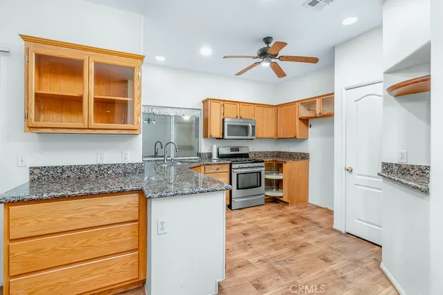 a kitchen with stainless steel appliances granite countertop a stove and a refrigerator