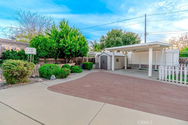 a view of a house with a yard and potted plants