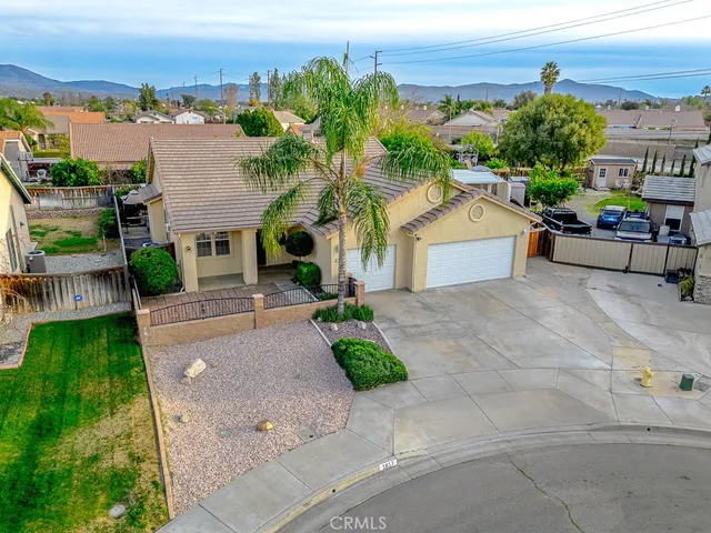 an aerial view of a house with yard and lake view