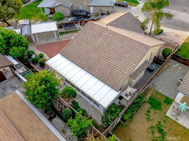 an aerial view of a house with a yard and potted plants