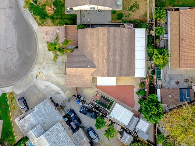 an aerial view of a house with a yard