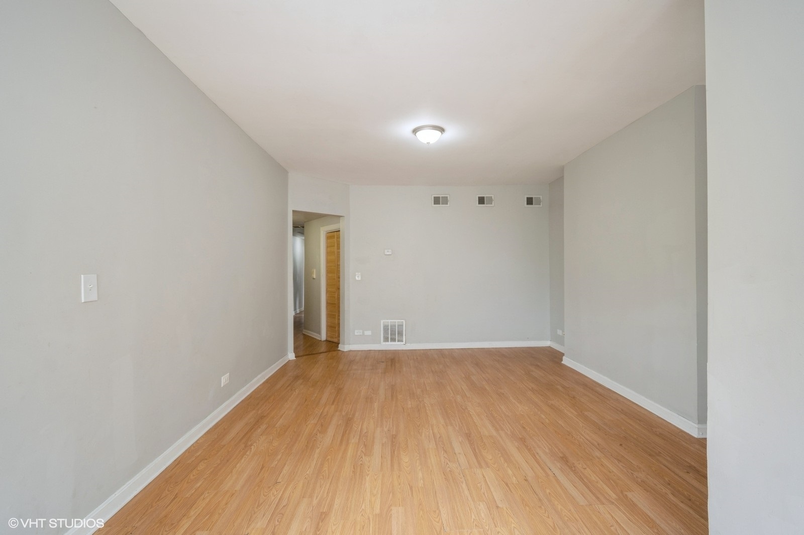6007 South Michigan Avenue, Unit 3 Chicago, IL 60637 - Photo 2 of 9 a view of empty room with wooden floor