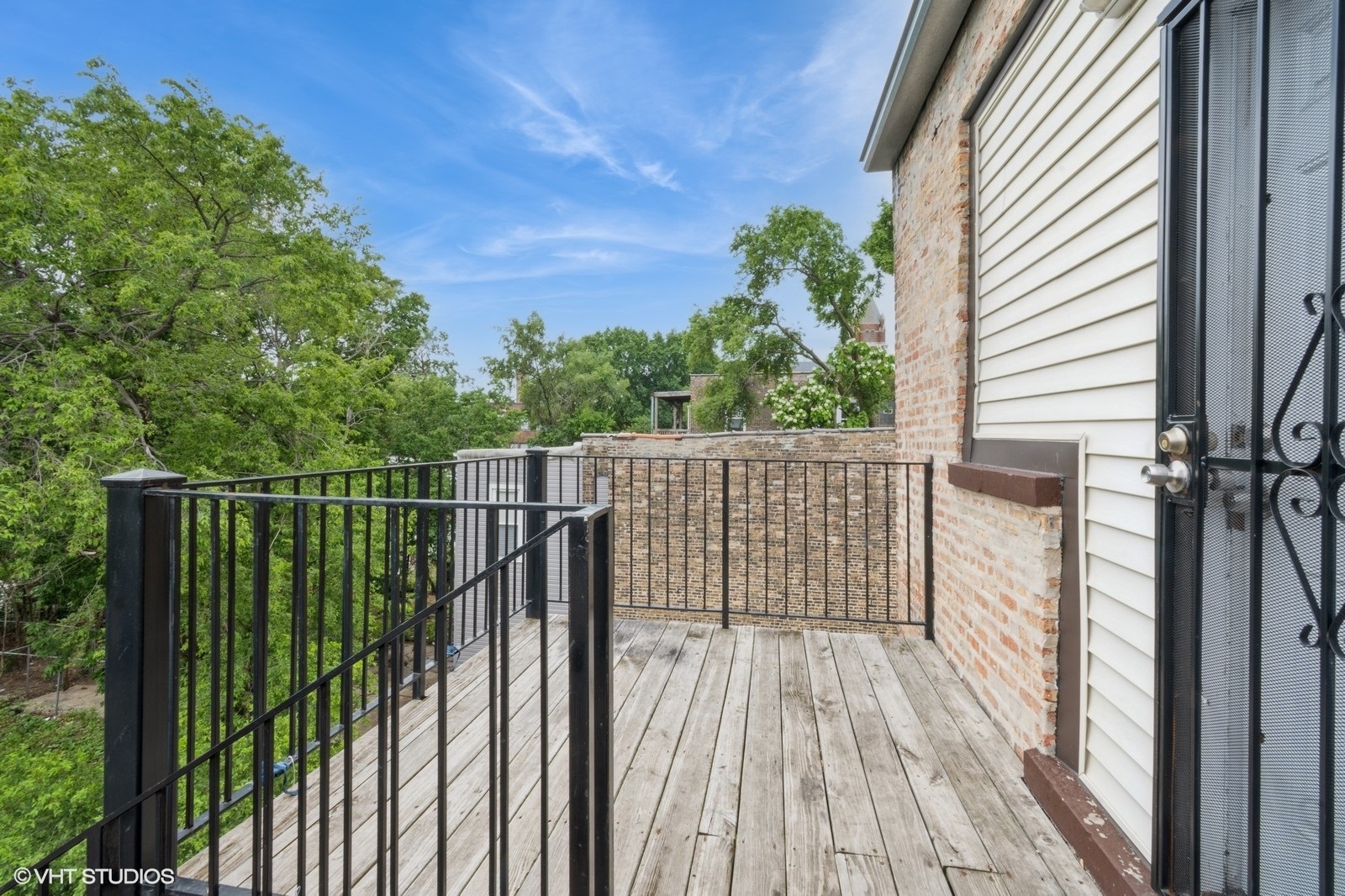 6007 South Michigan Avenue, Unit 3 Chicago, IL 60637 - Photo 9 of 9 a view of a balcony with wooden floor