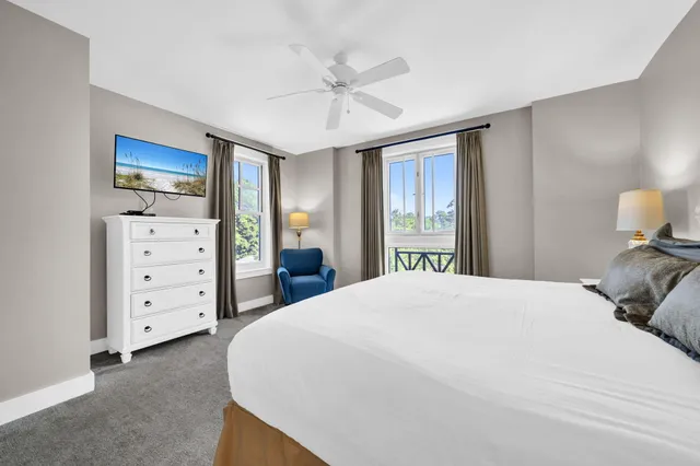 a bedroom with a bed a couch and a chandelier