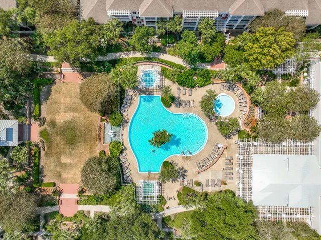 a view of a swimming pool with outdoor seating