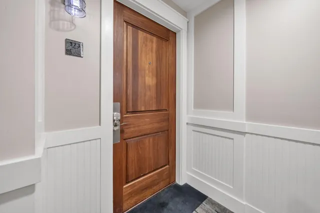 a view of a dining room with furniture and a chandelier