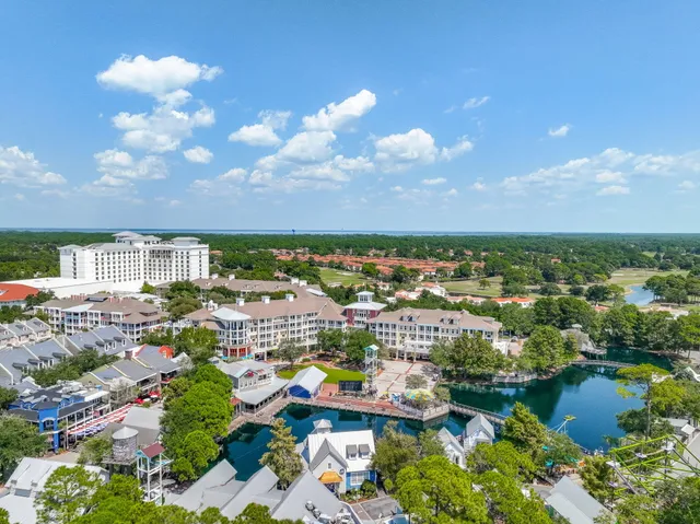 an aerial view of residential houses with outdoor space and river