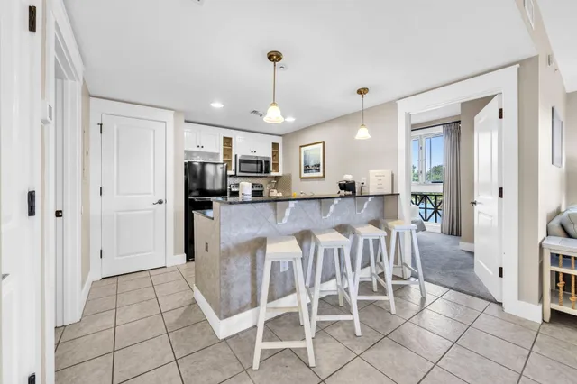 a large kitchen with a table and chairs