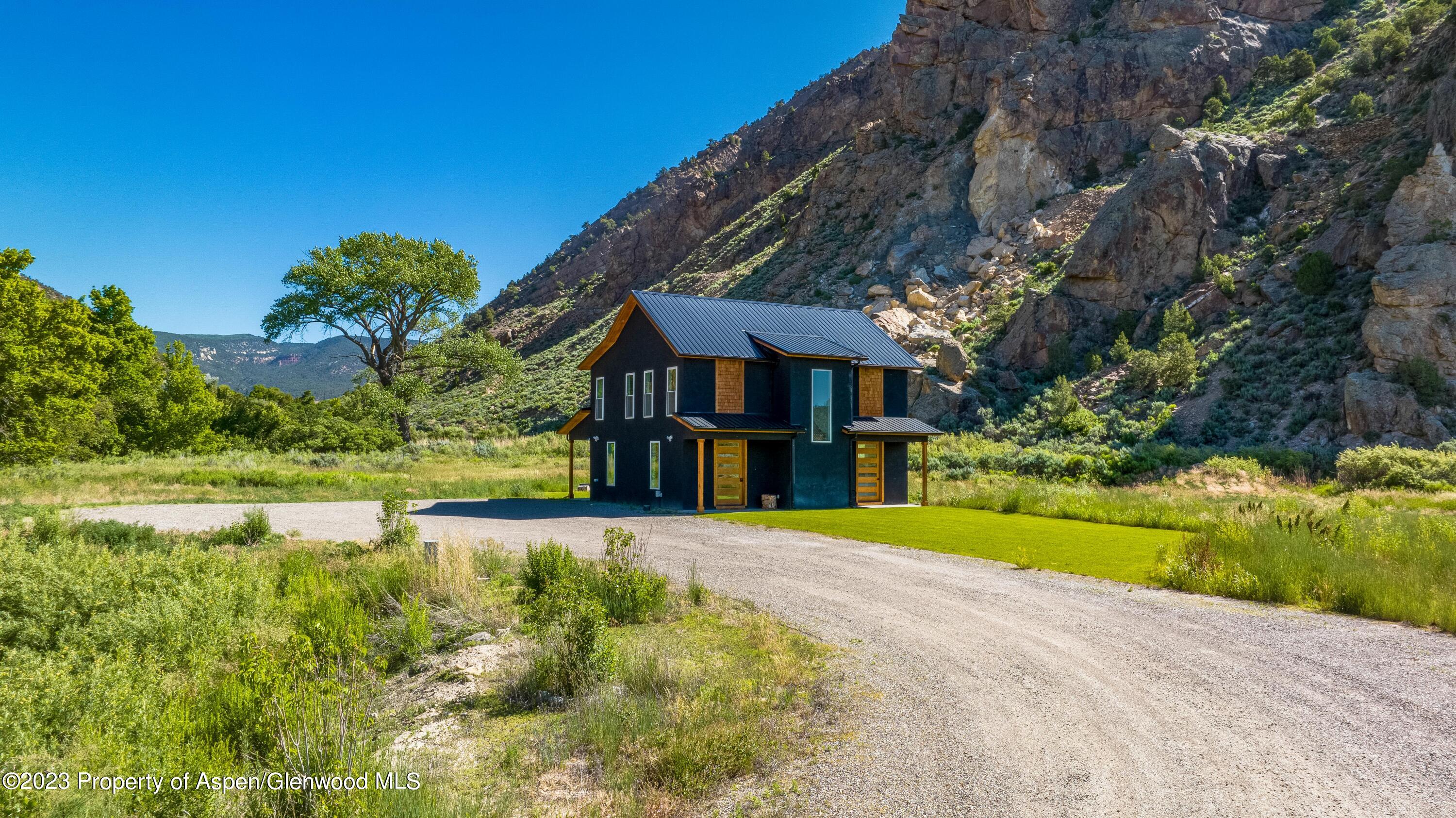 3200 Highway 325 Rifle, CO 81650 - Photo 3 of 27 a front view of a house with a yard