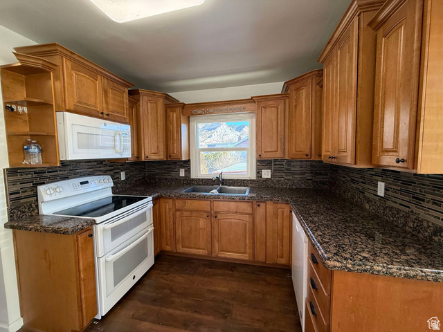 73 Garden Street Helper, UT 84526 - Photo 16 of 36 Kitchen featuring white appliances, open shelves, wood finish cabinets, and dark wood finished floors
