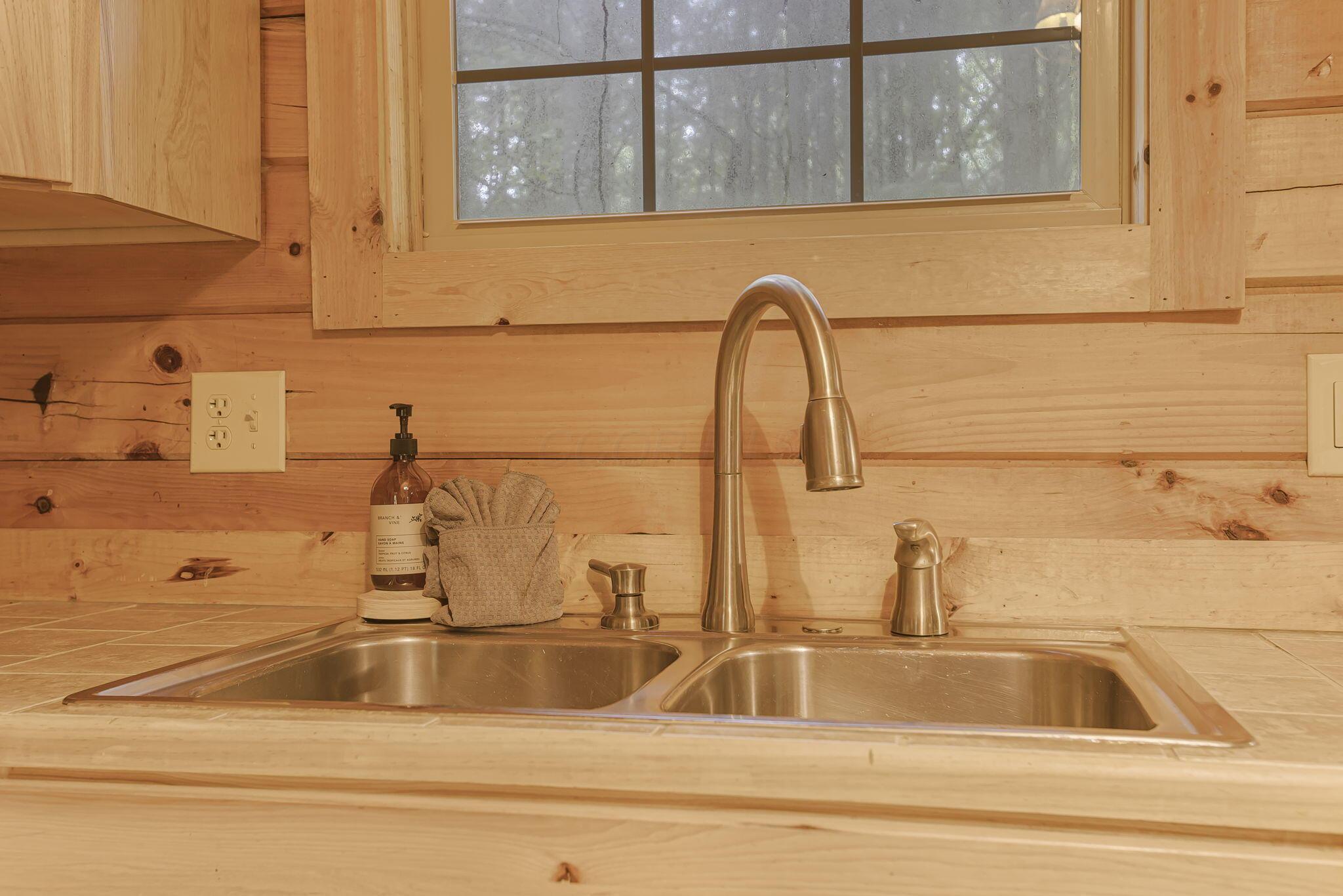 19475 Linden Road Logan, OH 43138 - Photo 22 of 94 Stainless steel double basin sink with a brushed nickel faucet, set within a light wood countertop