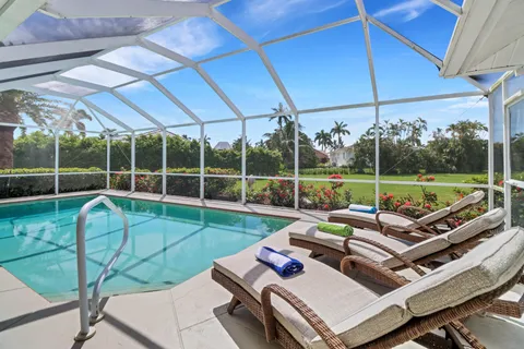 a view of a backyard with couches chair and city view